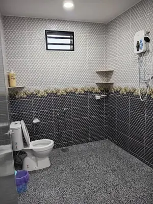 a bathroom with a toilet and a window at Balqis LN Homestay in Taiping