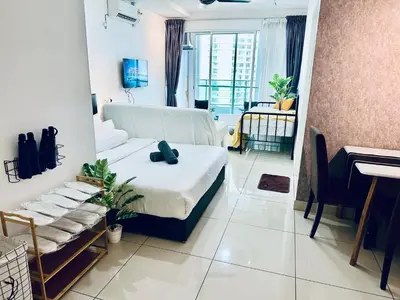 a bedroom with a bed and a living room at Muji 2B2R 12pax Sunrise Seaview Georgetown Suite in George Town
