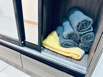 a pile of towels sitting on a window sill at Muji 2B2R 12pax Sunrise Seaview Georgetown Suite in George Town