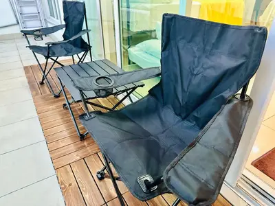 two black chairs and a table on a wooden floor at Muji 2B2R 12pax Sunrise Seaview Georgetown Suite in George Town