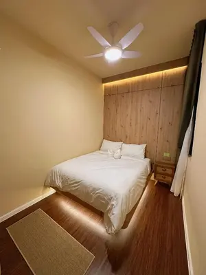 a bedroom with a bed with a ceiling fan at The Cozy Wooden Stay #PalasHorizon#5-7 minutes to Kea Farm in Brinchang