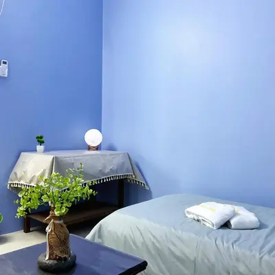 a blue room with two beds and a table with a plant at 10min near Ipoh Town Family Old & New Style 8Px in Ipoh