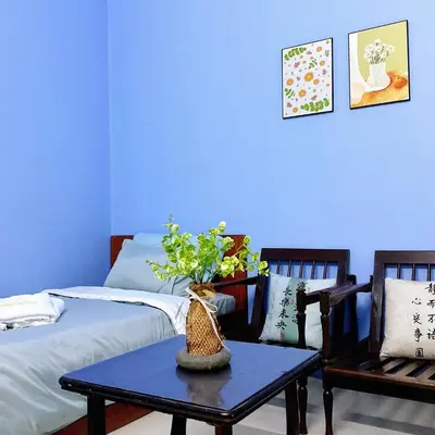a blue room with a table and two beds at 10min near Ipoh Town Family Old & New Style 8Px in Ipoh