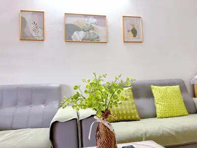 a living room with a couch with a vase on a table at 10min near Ipoh Town Family Old & New Style 8Px in Ipoh
