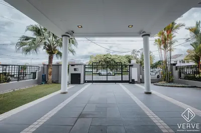 an open gate in a driveway with palm trees at Luxe Retreat Homestay by Verve in Ipoh