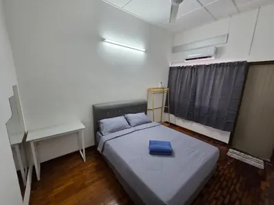 a small room with a bed and a desk at Ipoh Stadium Hostel in Ipoh