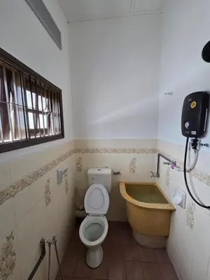 a bathroom with a toilet and a bath tub at Ipoh Stadium Hostel in Ipoh