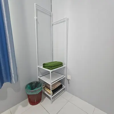 a towel rack in a bathroom with a green towel at Residensi Lourve Homestay Sungai Petani in Sungai Petani