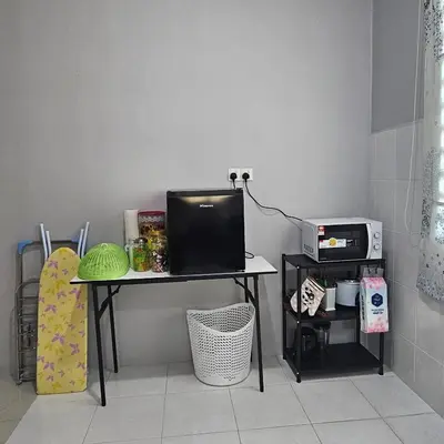 a desk with a computer on it in a room at Residensi Lourve Homestay Sungai Petani in Sungai Petani