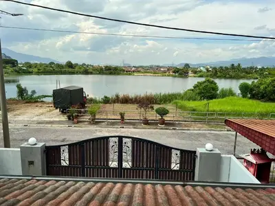 a view of a lake from a house at Lake View From Bed Peaceful Getaway Home in Ipoh