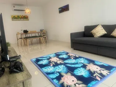 a living room with a couch and a blue rug at Big Big Big family escape 4BR side pool view, Ipoh in Ipoh