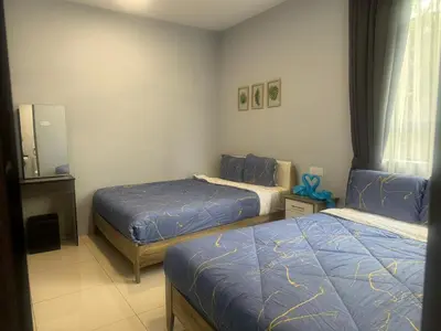 a bedroom with two beds and a mirror at Big Big Big family escape 4BR side pool view, Ipoh in Ipoh