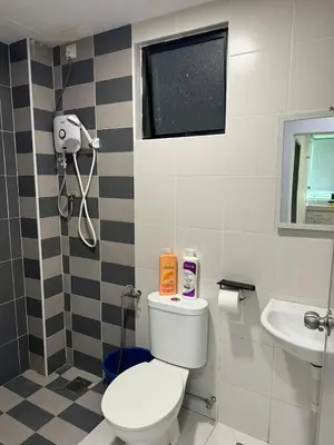 a bathroom with a toilet and a sink at Big Big Big family escape 4BR side pool view, Ipoh in Ipoh