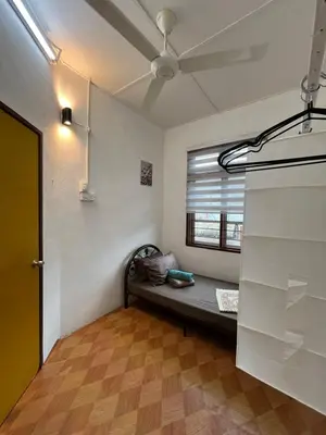 a room with a couch in a room with a window at Santai DPermai Homestay in Selama