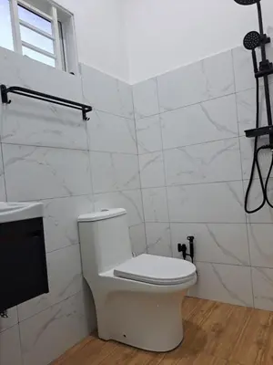 a white bathroom with a toilet and a sink at Teratak Sumayyah 2 - For Islam only - Pondok Lenggong in Kampong Banggol Belimbing