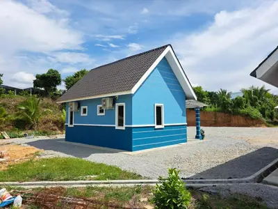 a blue house with a black roof at Teratak Sumayyah 2 - For Islam only - Pondok Lenggong in Kampong Banggol Belimbing