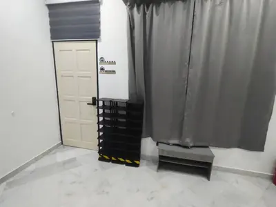 a garage with black curtains and a white door at sunshine bnb concept service in Ipoh