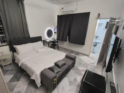 a bedroom with a bed and a couch in a room at sunshine bnb concept service in Ipoh