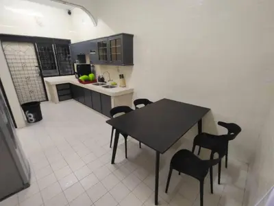 a kitchen with a table and chairs in it at sunshine bnb concept service in Ipoh
