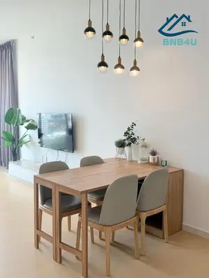a dining room with a wooden table and chairs at Beacon Executive Suite in Jalan Sungai Pinang George Town in George Town