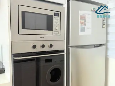 a refrigerator next to a microwave and a oven at Beacon Executive Suite in Jalan Sungai Pinang George Town in George Town