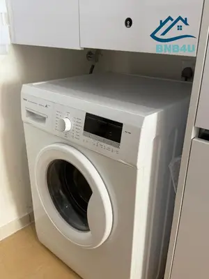 a white washing machine sitting in a room at Beacon Executive Suite in Jalan Sungai Pinang George Town in George Town