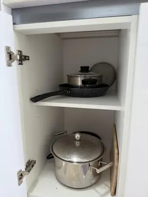 a cabinet with a pot and a pan in it at Beacon Executive Suite in Jalan Sungai Pinang George Town in George Town