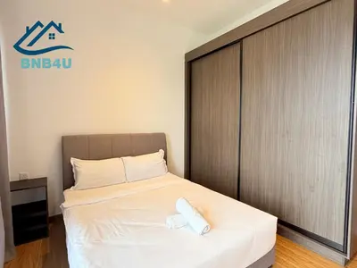 a bed in a room with a sign on the wall at Beacon Executive Suite in Jalan Sungai Pinang George Town in George Town