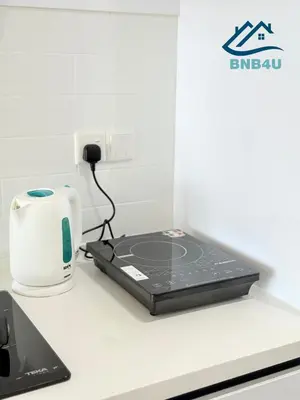 a laptop sitting on top of a kitchen counter at Beacon Executive Suite in Jalan Sungai Pinang George Town in George Town