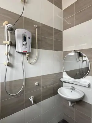 a bathroom with a shower with a sink and a mirror at Silibin Family 4B3B Homestay 11pax by Iconique in Ipoh