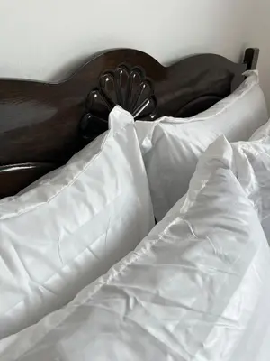 an unmade bed with white sheets and pillows at Silibin Family 4B3B Homestay 11pax by Iconique in Ipoh