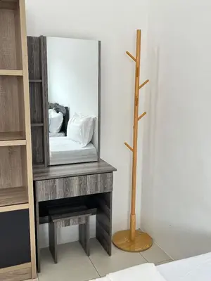 a mirror on a table with a bench and a stool at Silibin Family 4B3B Homestay 11pax by Iconique in Ipoh
