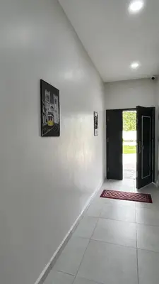 a room with a white wall with a door at Kuala Kubu Bharu Guesthouse Hotel in Kuala Kubu Baharu