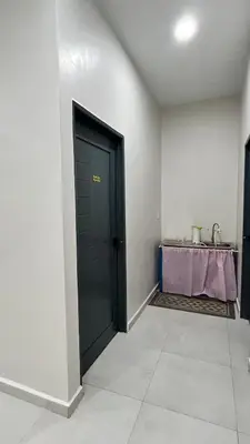 a black door in a room with a table at Kuala Kubu Bharu Guesthouse Hotel in Kuala Kubu Baharu