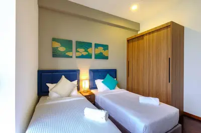 two beds sitting next to each other in a room at Seaview Studio 2BR 3BR Tanjung Point Residences in Tanjong Tokong