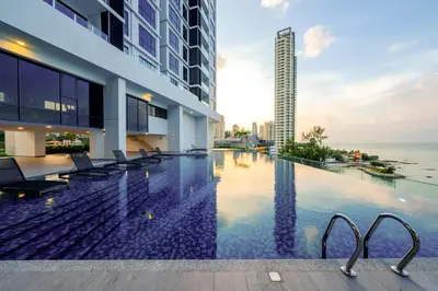 a swimming pool in a building with a view of the ocean at Seaview Studio 2BR 3BR Tanjung Point Residences in Tanjong Tokong