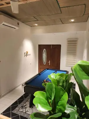 a room with a pool table and a potted plant at Sun Vista Home by Ipoh Maju Stay in Ipoh