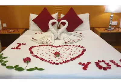 two swans made out of roses on a bed at Cameron Nova Highlands Resort VI in Brinchang
