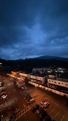 a city with cars parked in a parking lot at The White Mist Cameron in Tanah Rata