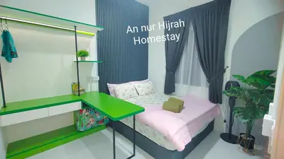 a small bedroom with a bed and a desk at Homestay Annur Hijrah Seri Iskandar Near UiTM ,UTP in Seri Iskandar