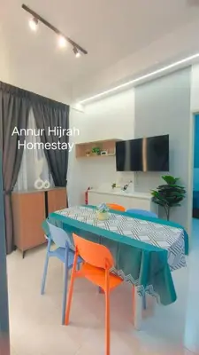 a living room with a table and two chairs at Homestay Annur Hijrah Seri Iskandar Near UiTM ,UTP in Seri Iskandar