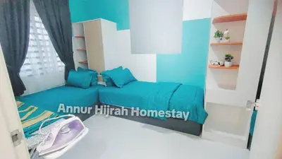 a bedroom with a blue couch in a room at Homestay Annur Hijrah Seri Iskandar Near UiTM ,UTP in Seri Iskandar