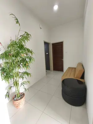 a room with a bed and a plant in it at RoomB w attached bathroom w bathtub in George Town