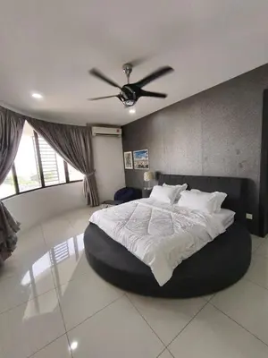 a bedroom with a large bed with a ceiling fan at RoomB w attached bathroom w bathtub in George Town