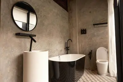 a bathroom with a sink and a mirror and a toilet at Playce Hotel in George Town