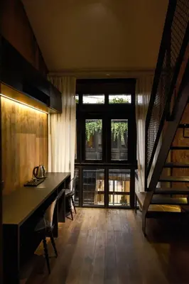 a living room with a table and a large window at Playce Hotel in George Town