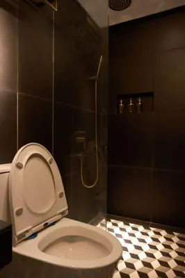 a bathroom with a toilet and a shower at Playce Hotel in George Town