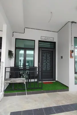 a patio with a bench and a table in a building at Sofea Stay Homestay Sungai Petani in Sungai Petani
