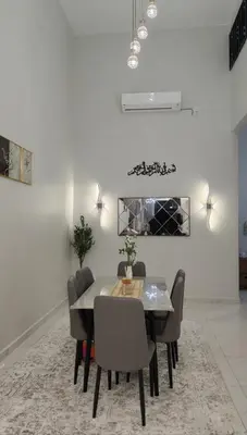 a dining room with a table and chairs at Sofea Stay Homestay Sungai Petani in Sungai Petani