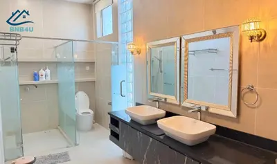 a bathroom with two sinks and a glass shower at Landed Spacious House at Cangkat Delima Gelugor Penang in Gelugor